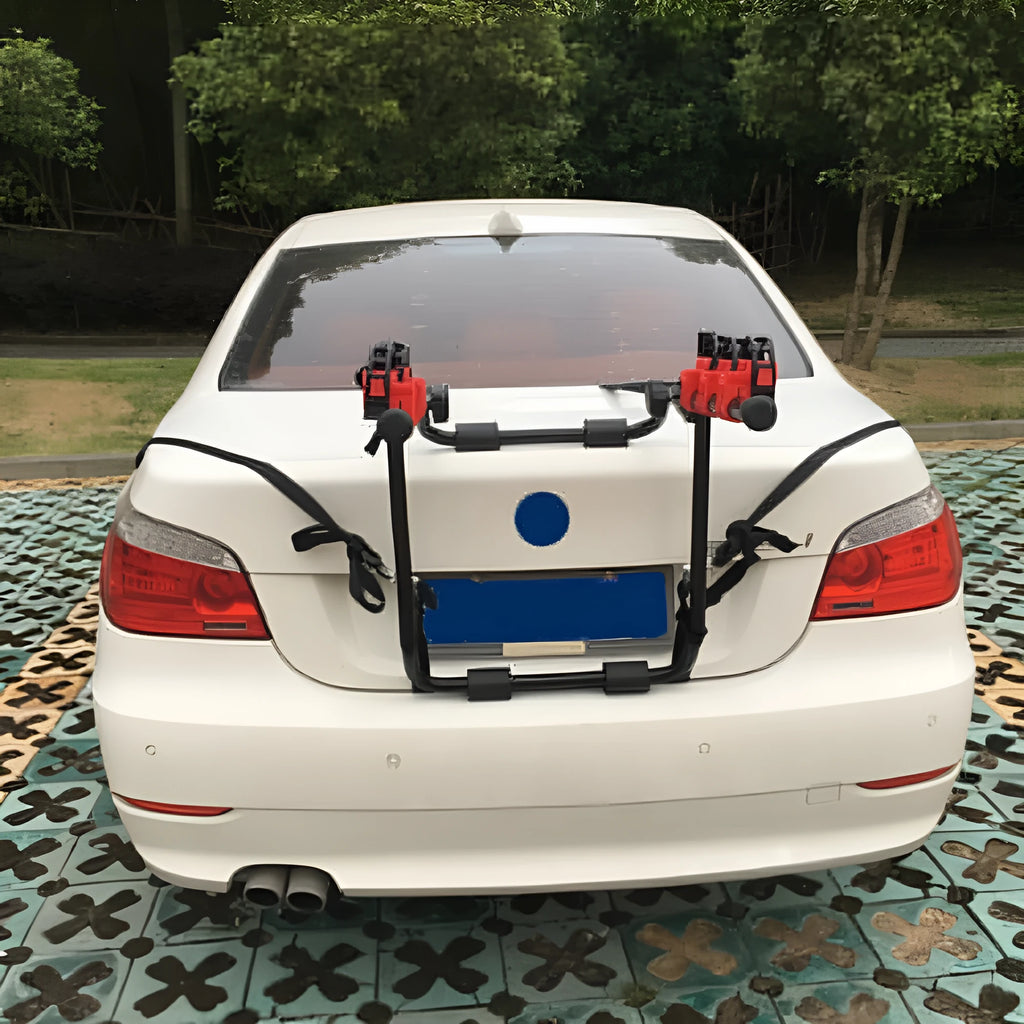 Black and red trunk-mounted bicycle carrier rack with tie ropes and protective sponge padding.