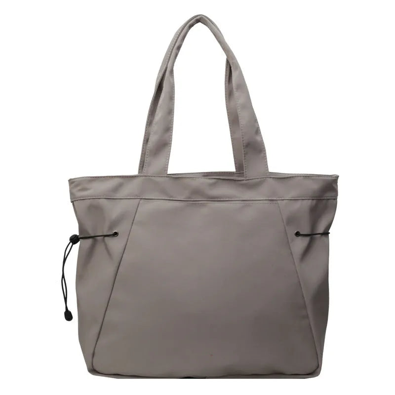 Soft Oxford cloth foldable tote bag shown in one of five colours: black, brown, dark grey, light grey, or purple.