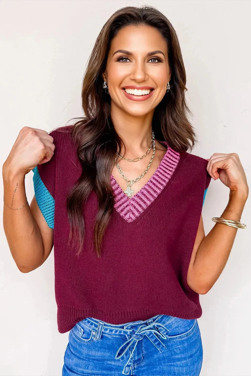 Burgundy v neck short sleeve sweater with contrast trim and loose fit on a woman
