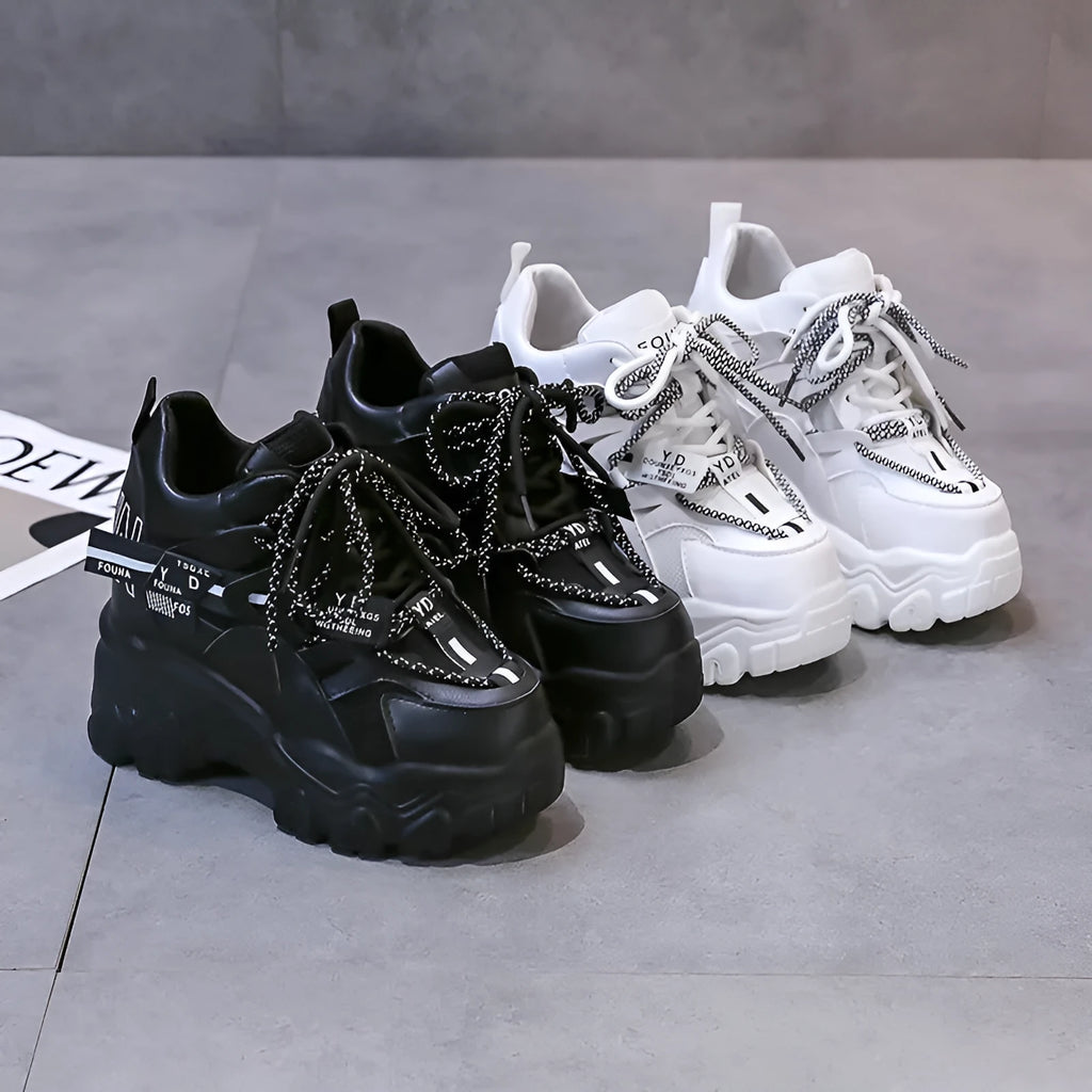 White women's mesh platform sports shoes with cross-strap detail and rubber sole.