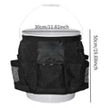 Black cylindrical polyester storage bag hanging on a 5-gallon water barrel for organising tools and gear.