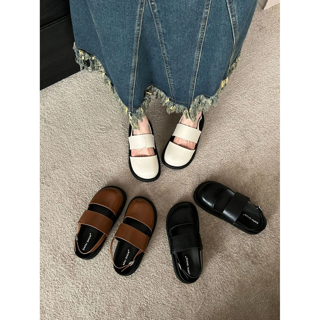 Retro brown platform sandals with a single ankle strap buckle and closed round toe.