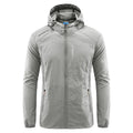Man wearing a lightweight grey hooded nylon summer jacket outdoors.