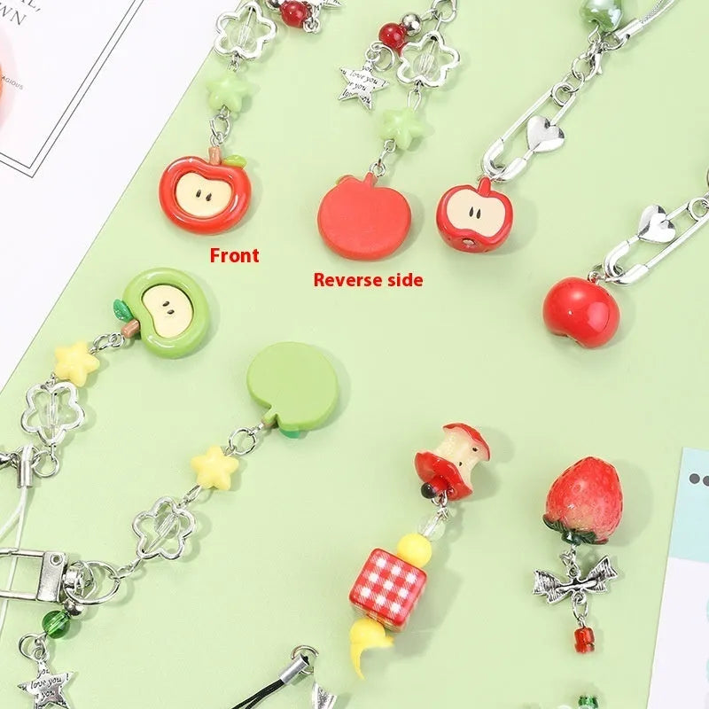 Cute fruit design mobile phone charm keychain in plastic resin with apple or strawberry motif.