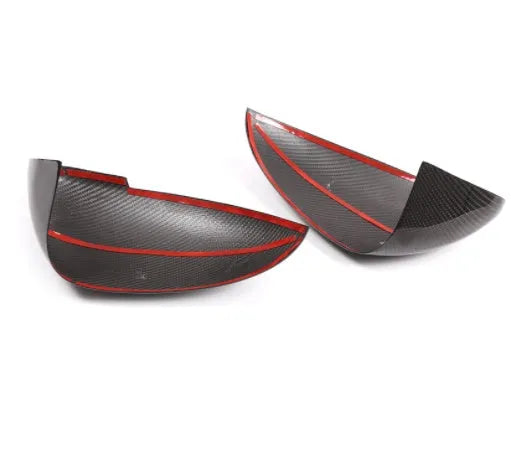 Genuine carbon fibre rearview mirror covers for a Porsche Macan, showing glossy black weave texture.