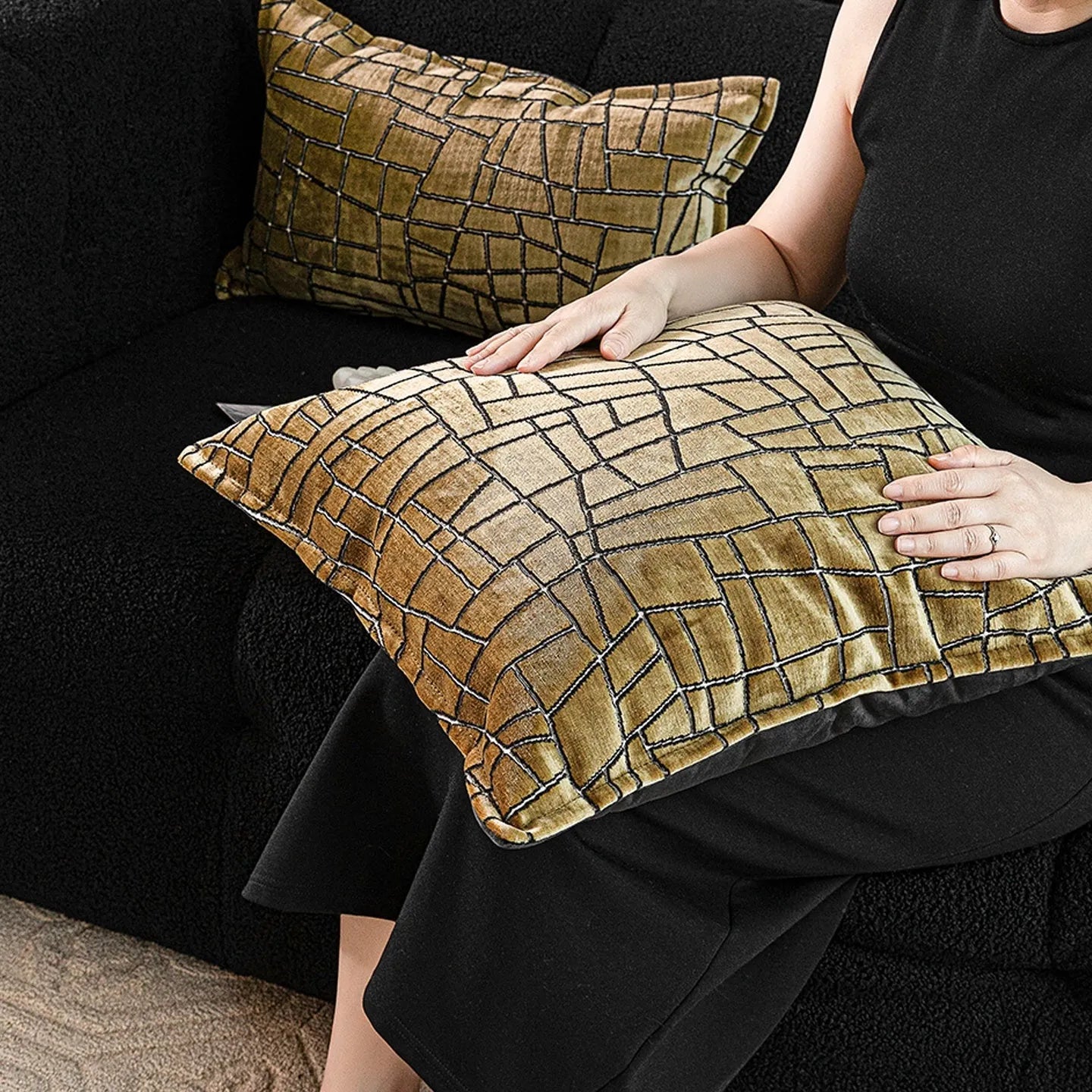 Geometric abstract patterned cushion in local gold colour, shown in square and lumbar sizes on a grey sofa.