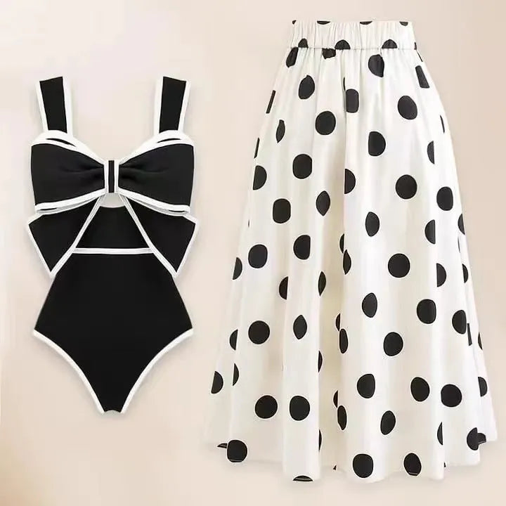 Women's black one-piece swimsuit with a white bow and round skirt, made from polyester.