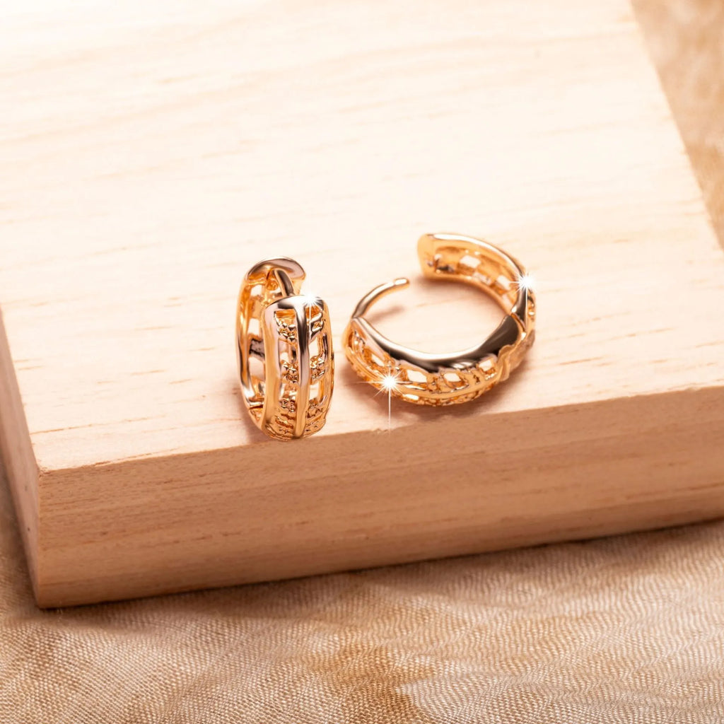 Copper hollowed-out leaf and heart shaped earrings with rose gold finish showing geometric patterns