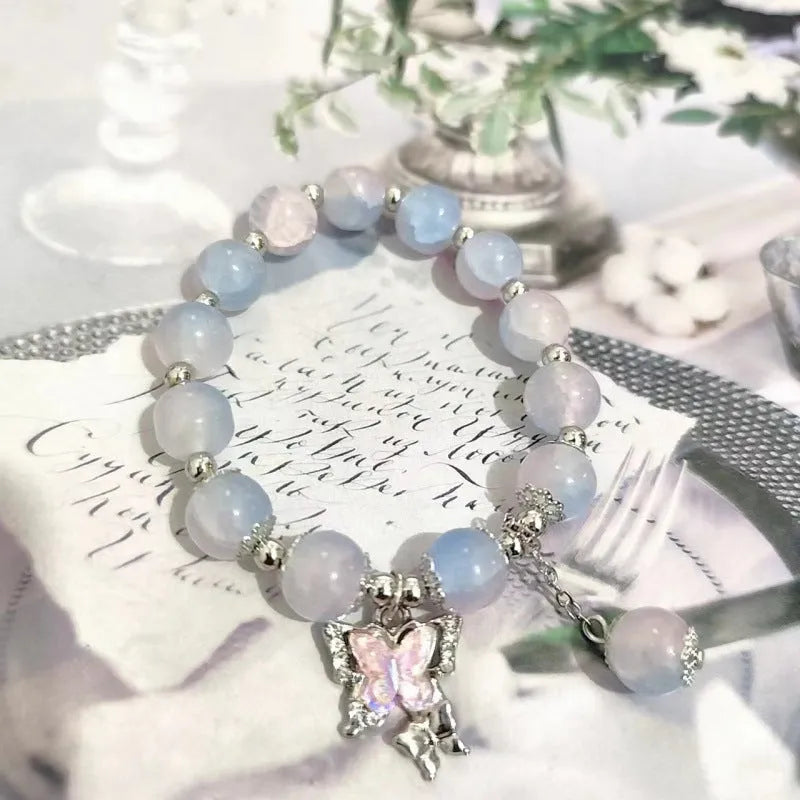 Chinese style handmade glass bead bracelet with bamboo joint elements on a white background.