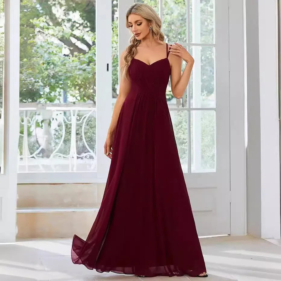 A sleeveless light green women's dress with a pleated A-line long skirt on a mannequin.