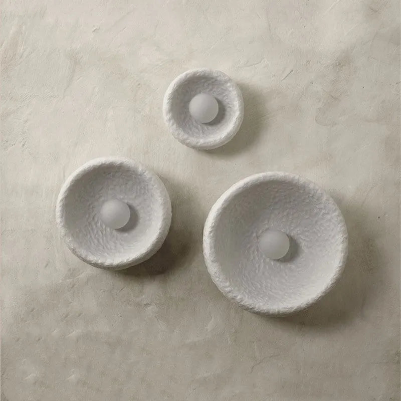 Japanese-style modern simple wall lamp with a round resin shade in warm white light.
