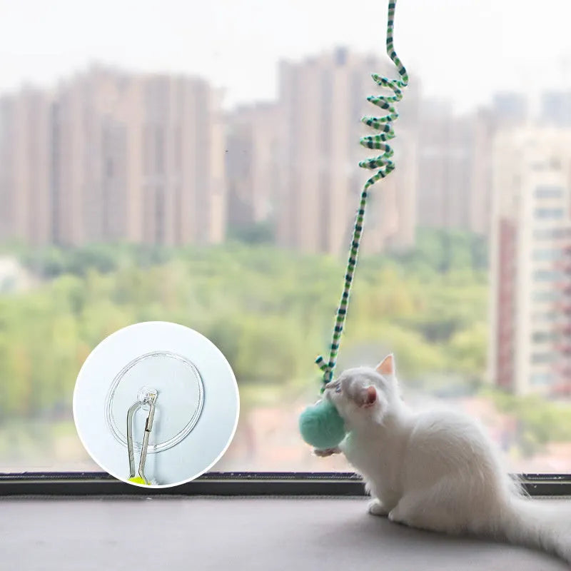Spring cat toy with inflatable ball and bell hanging from suction cup stick in multiple colour options