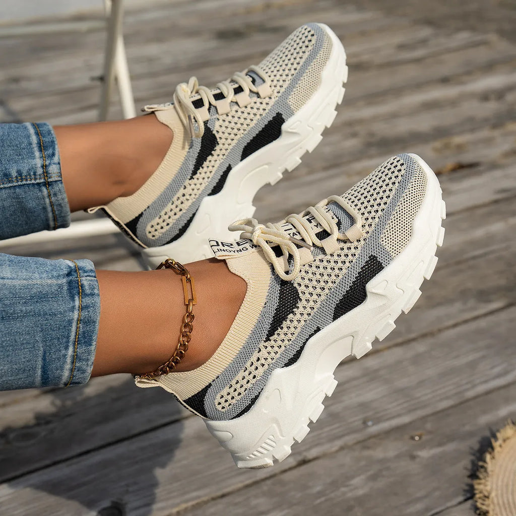 Women's Flyknit mesh lace-up sneakers in a multi-tonal colour with a flat rubber sole.