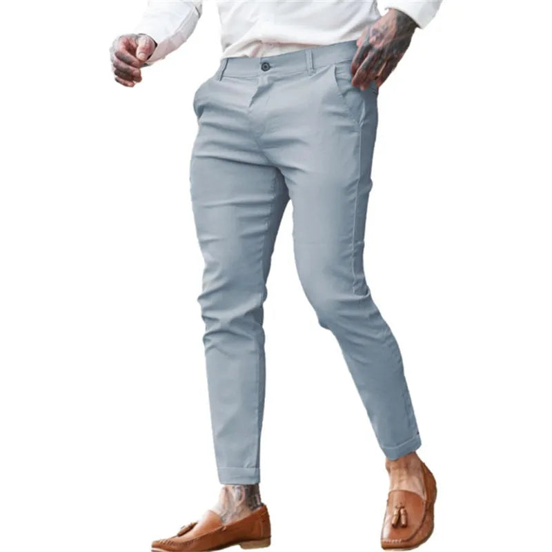 Men's slim fit pencil trousers in cotton twill fabric with stretch, showing mid waist and tapered leg.