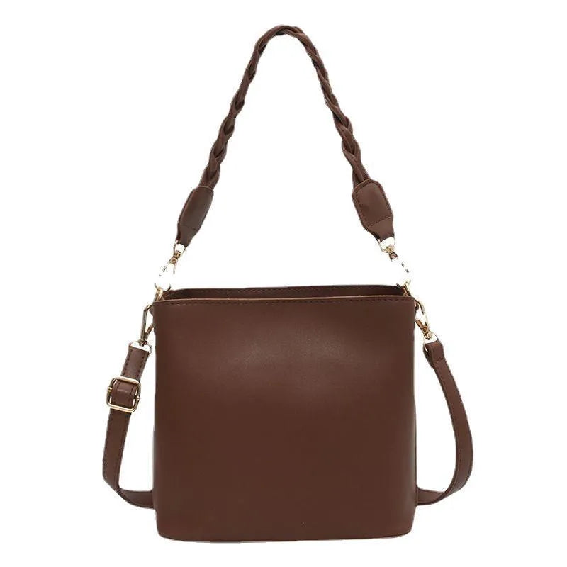 Unisex one-shoulder crossbody bucket bag in woven PU leather, shown in khaki colour.