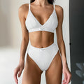 Women's embroidered black bikini set with contrast binding and shorts-length bottoms.