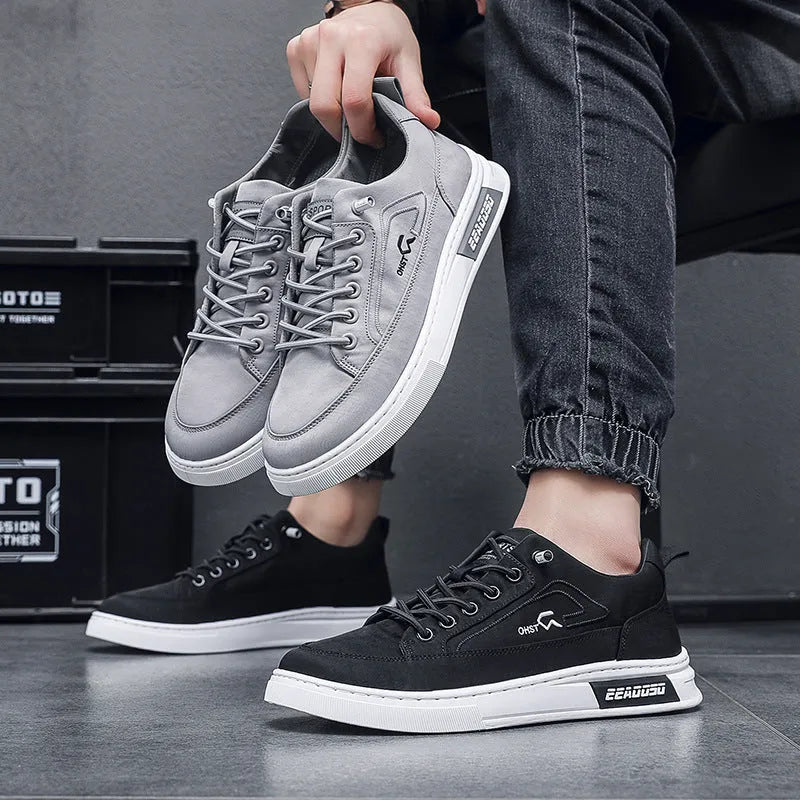 Grey men's low-top canvas casual shoes with a round toe and white rubber sole on a plain background.