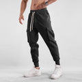 Men's loose cotton trousers with ankle ties and multiple pockets in solid apricot colour