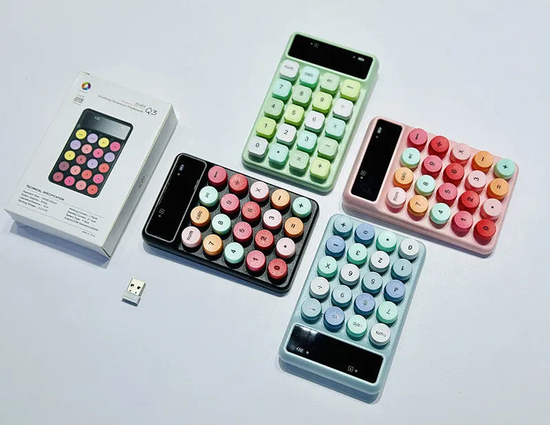Mini portable wireless keyboard in macaron mixed colours on a desk.