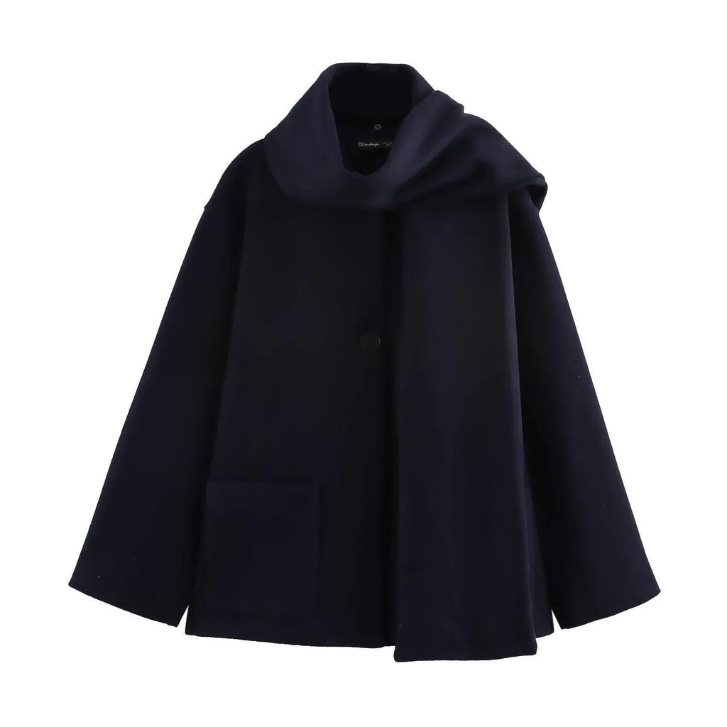 Women's long black polyester coat with a faux fur collar, shown in a street fashion style.