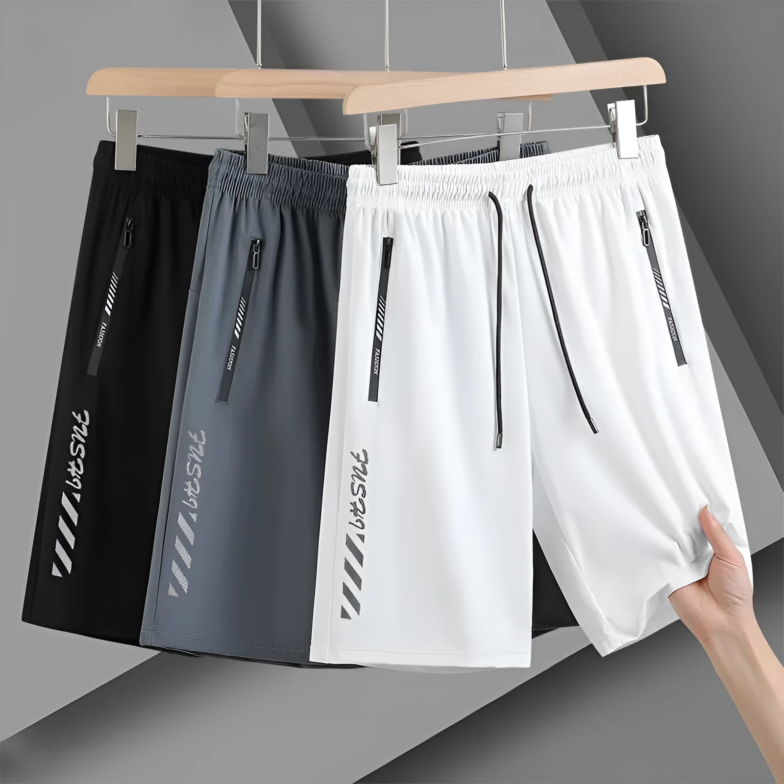 Man wearing loose fit black nylon sports shorts with an elastic waistband.