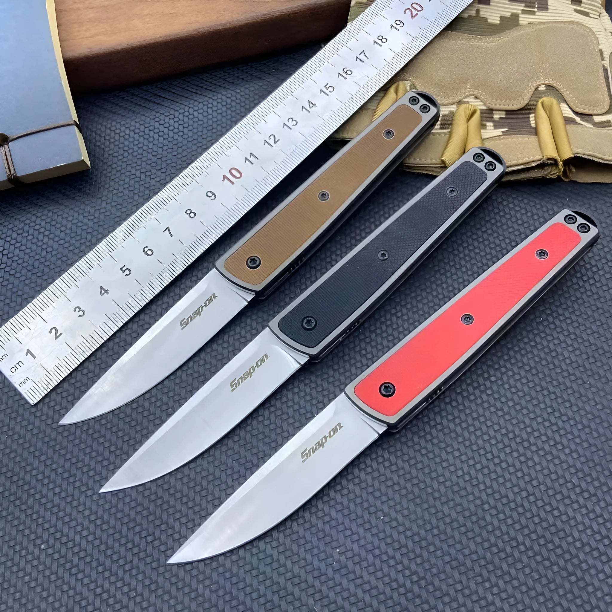 CRKT 7190 folding fruit knife showing blade and handle with colour options of black, brown, and red