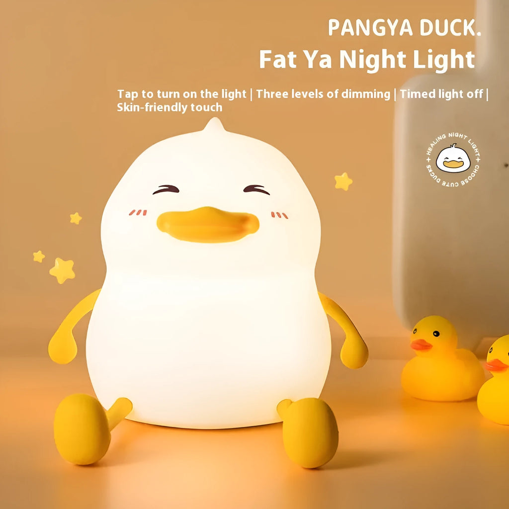 Chubby silicone rechargeable night light with phone holder on a desk