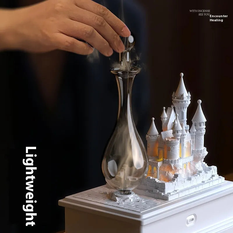 White medieval castle-shaped cold fragrance aromatherapy machine with ambient light on a table.