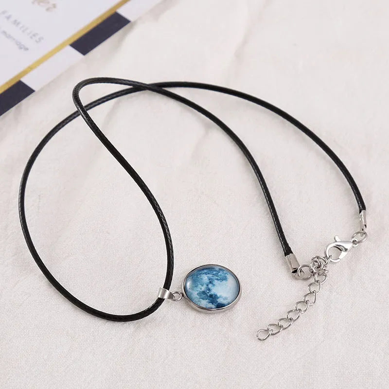 Luminous moon and constellation pendant necklace on a chain with an extension, shown in one of ten possible colours.