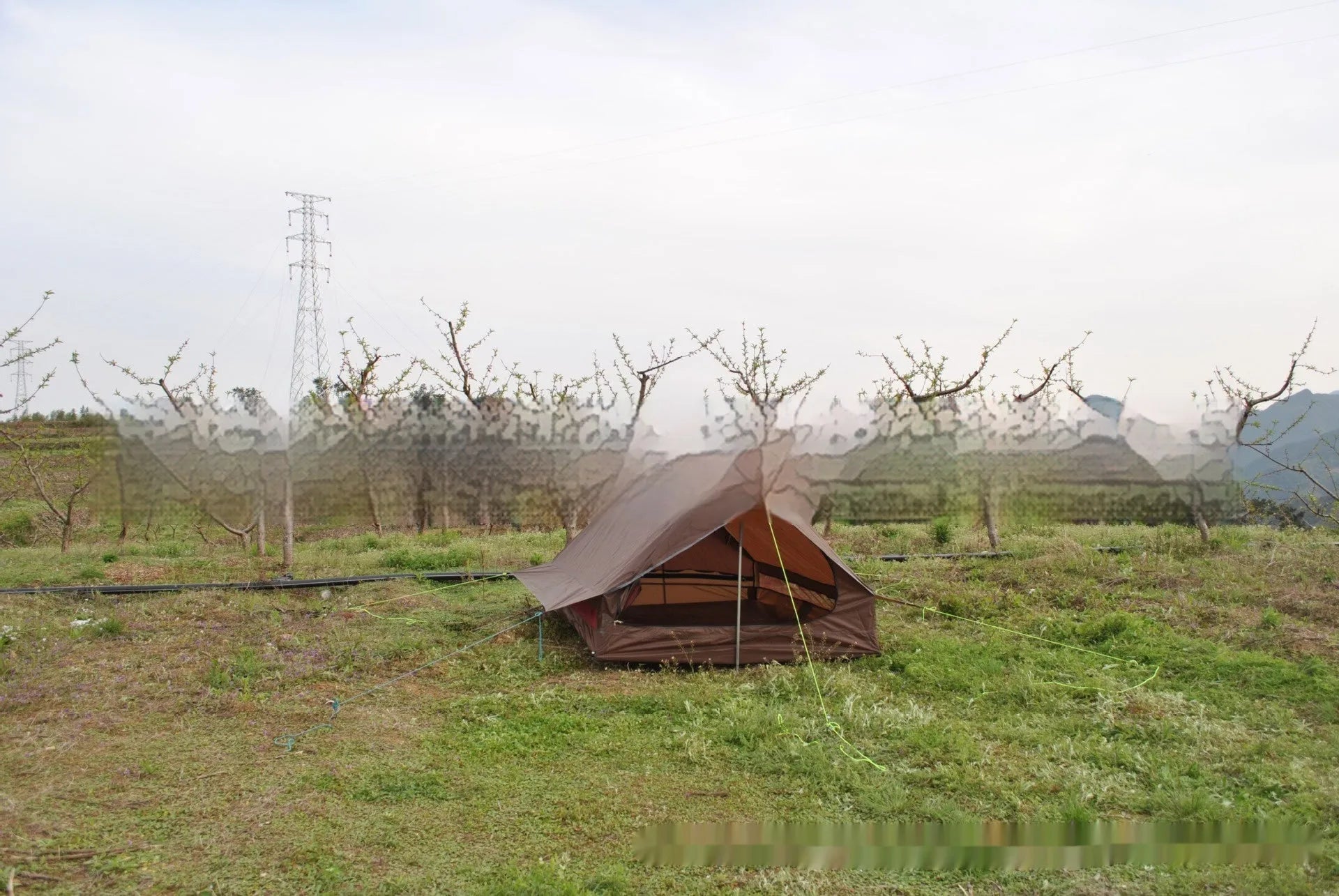 Brown and white pole-free A-line cabin tent set up with hiking canes, showing spacious interior