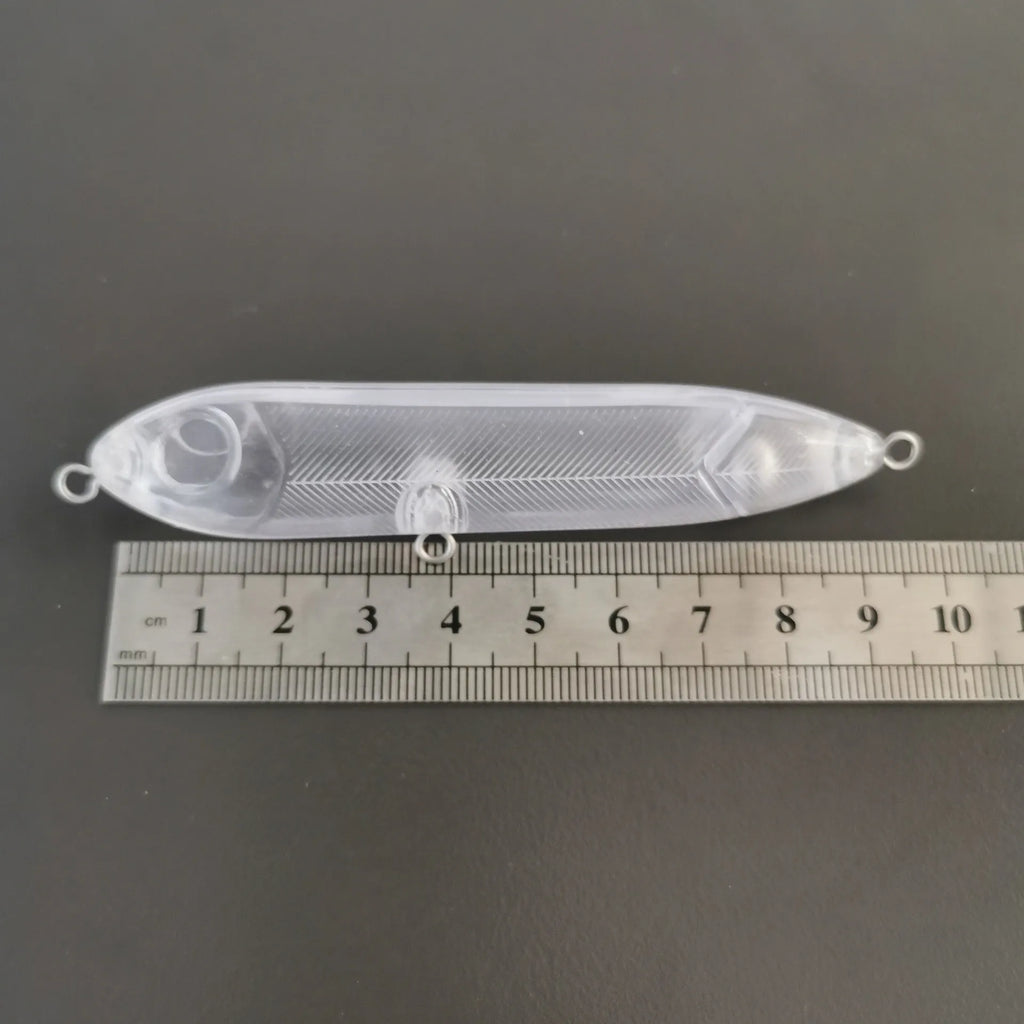 Transparent 9.5cm long blank soft plastic fishing bait body on a white background.
