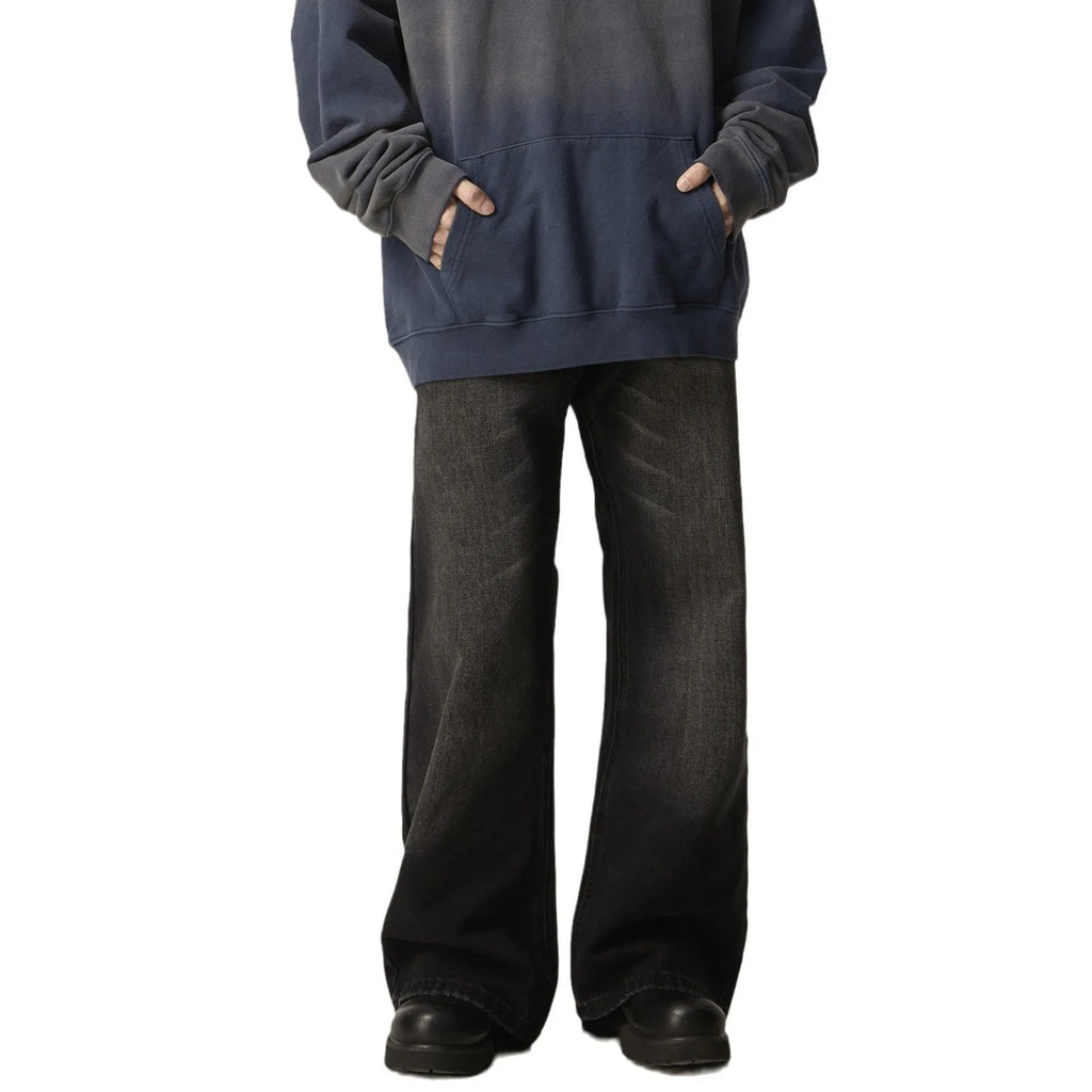 Black loose straight leg retro jeans on a hanger, showing zipper fly detail.