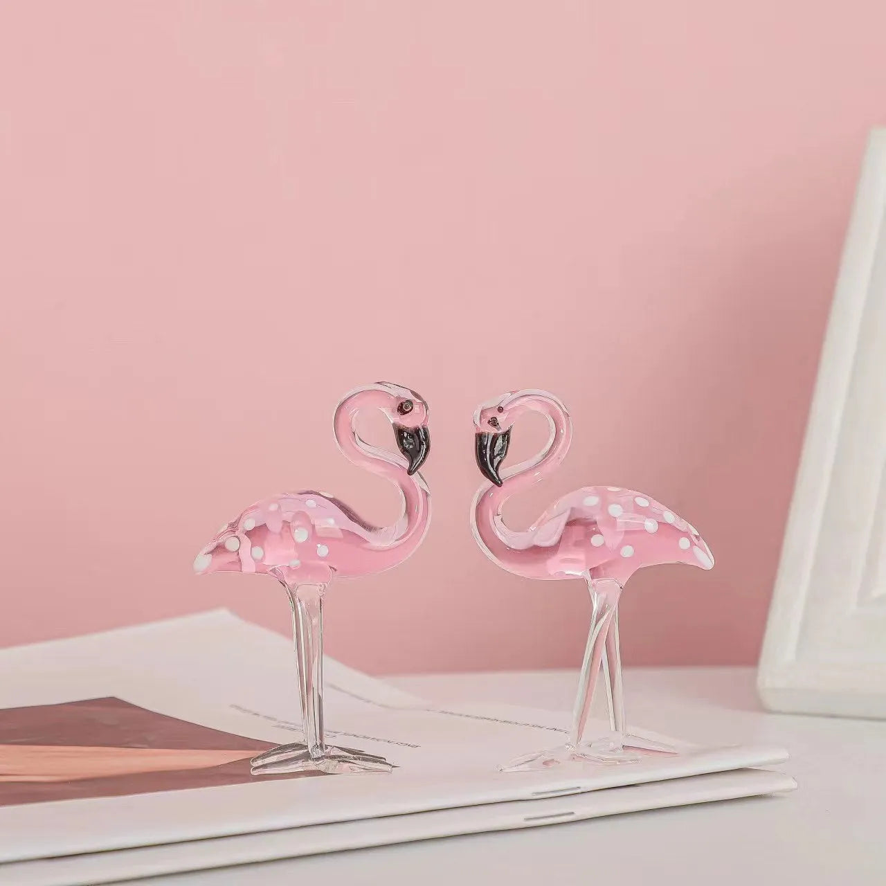 Pink flamingo crystal animal decoration on a tabletop in separate and juxtaposition styles.