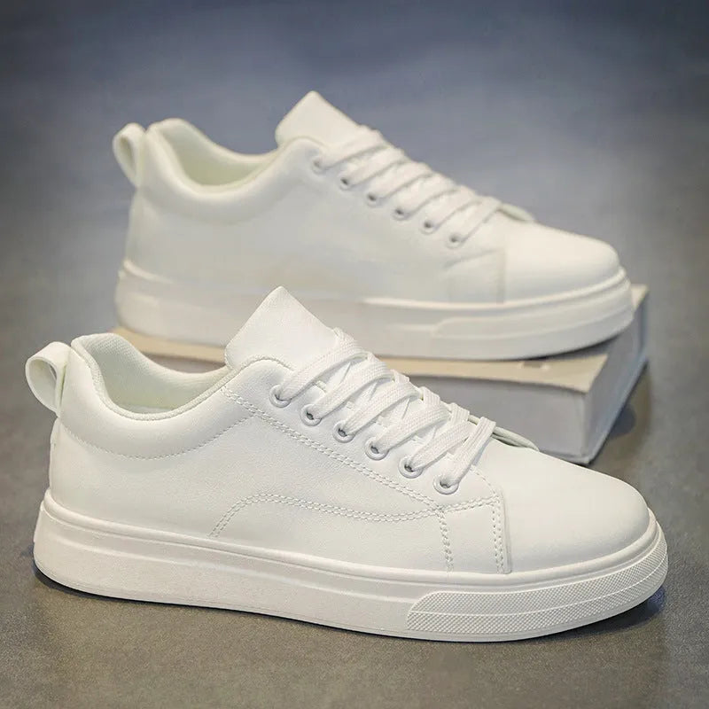 Men's low-top Korean-style sneakers in white, black, or black and white with a round toe and rubber sole.