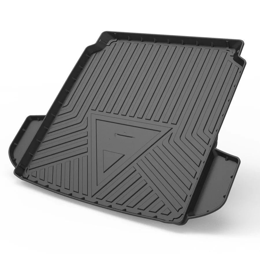 Black carbon fibre pattern TPE trunk pad installed in a car boot showing custom fit and textured surface