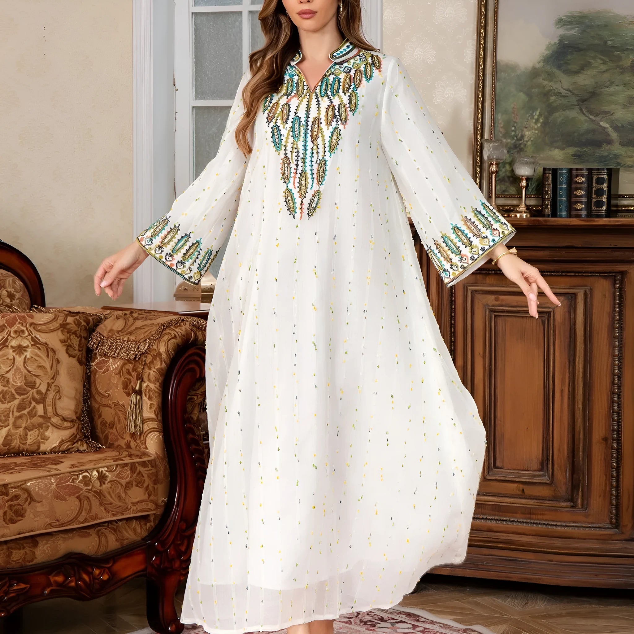 White women's Dubai Arabic robe with long sleeves and floor-length skirt.