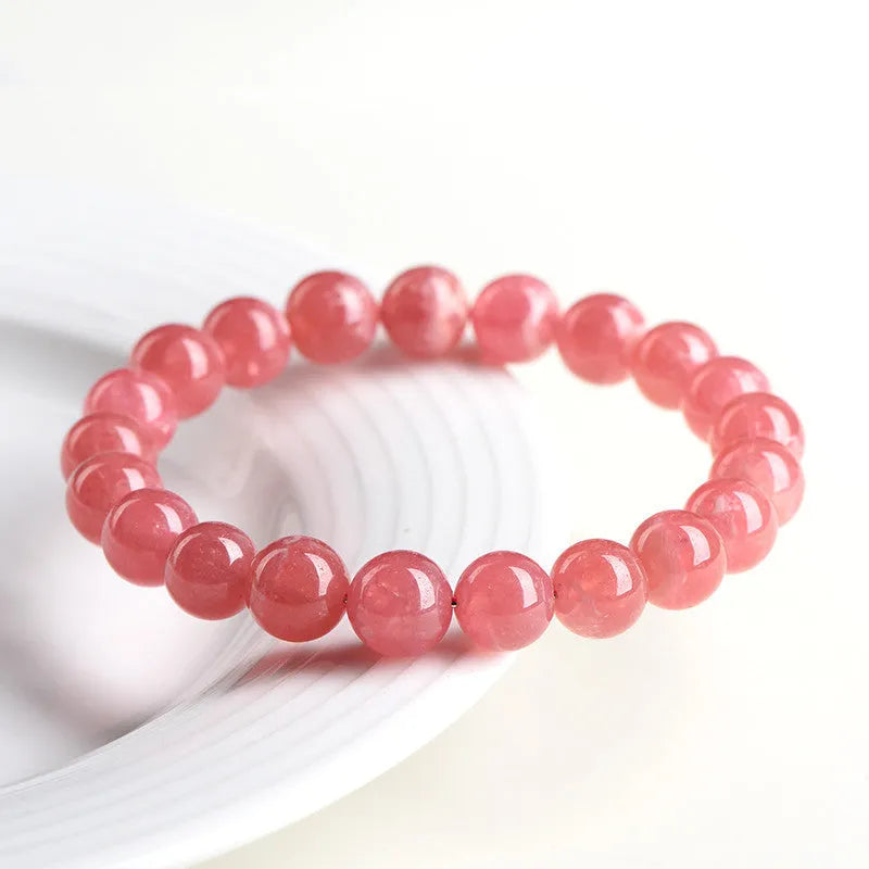 Women's red rhodochrosite crystal bracelet with geometric beads and Longevity Lock element.
