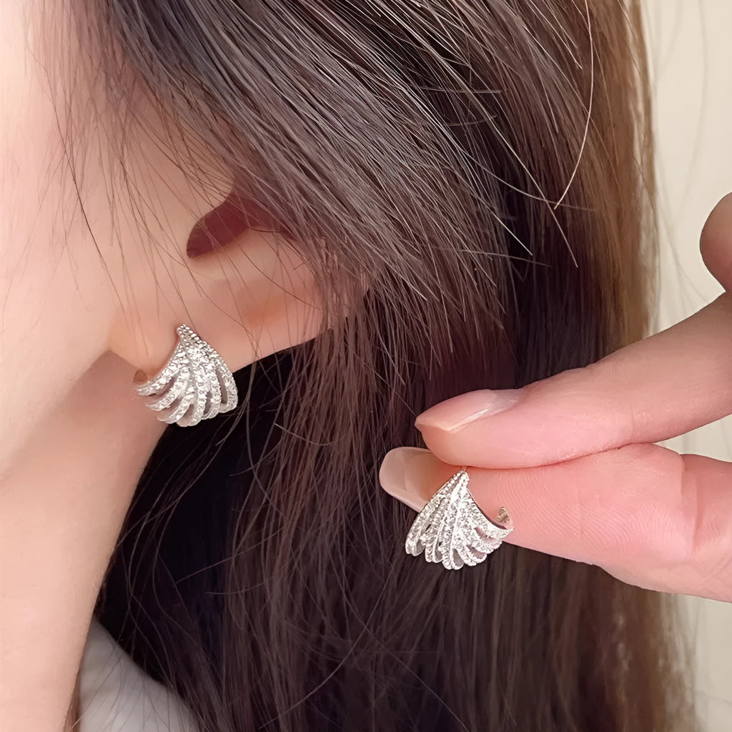 Pair of geometric line design earrings with platinum electroplated finish on zircon.
