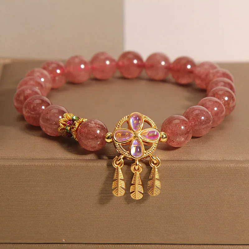 Women's strawberry quartz crystal bracelet with four leaf dream catcher ball pendant