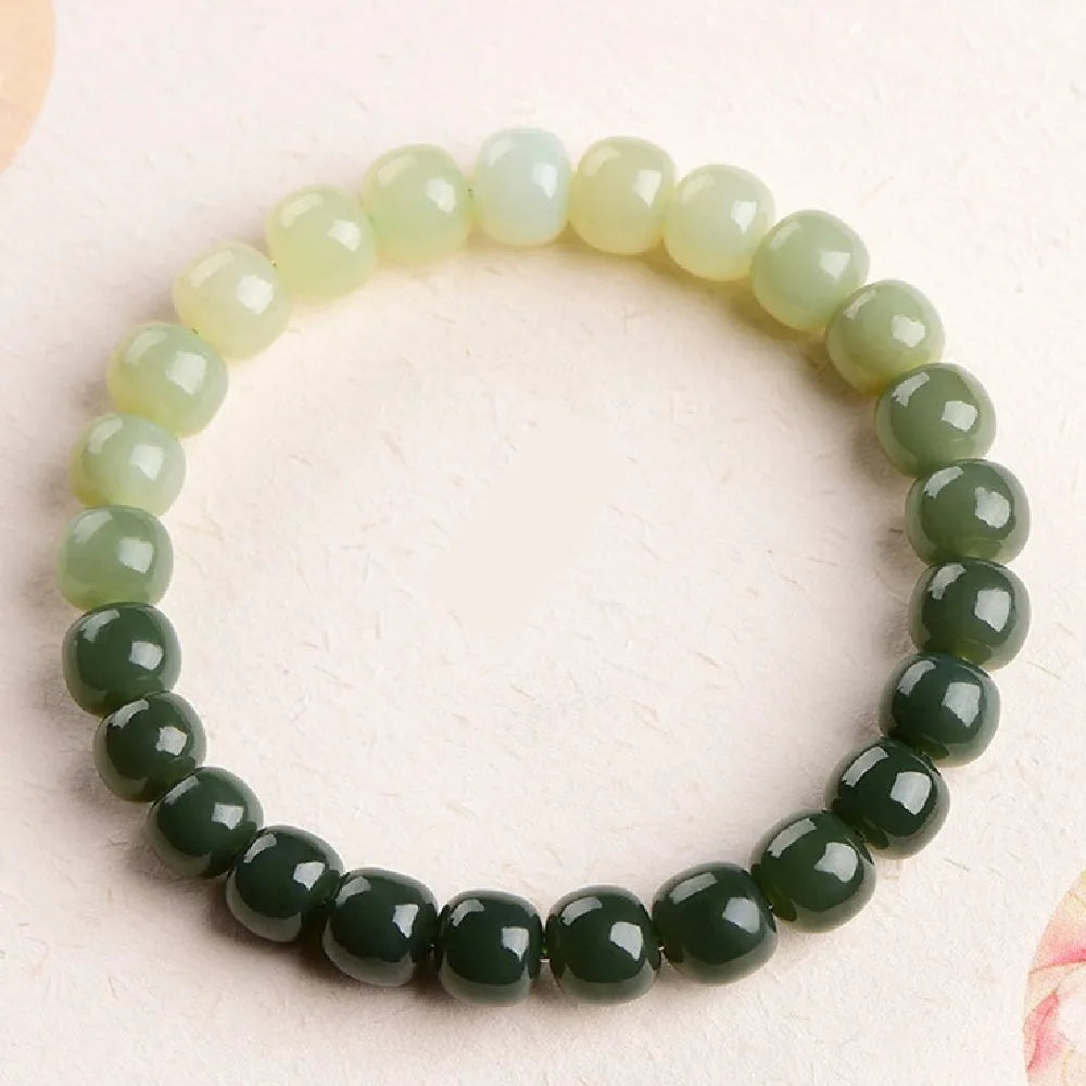 Natural Hetian jade bracelet showing water gradient colour on polished beads