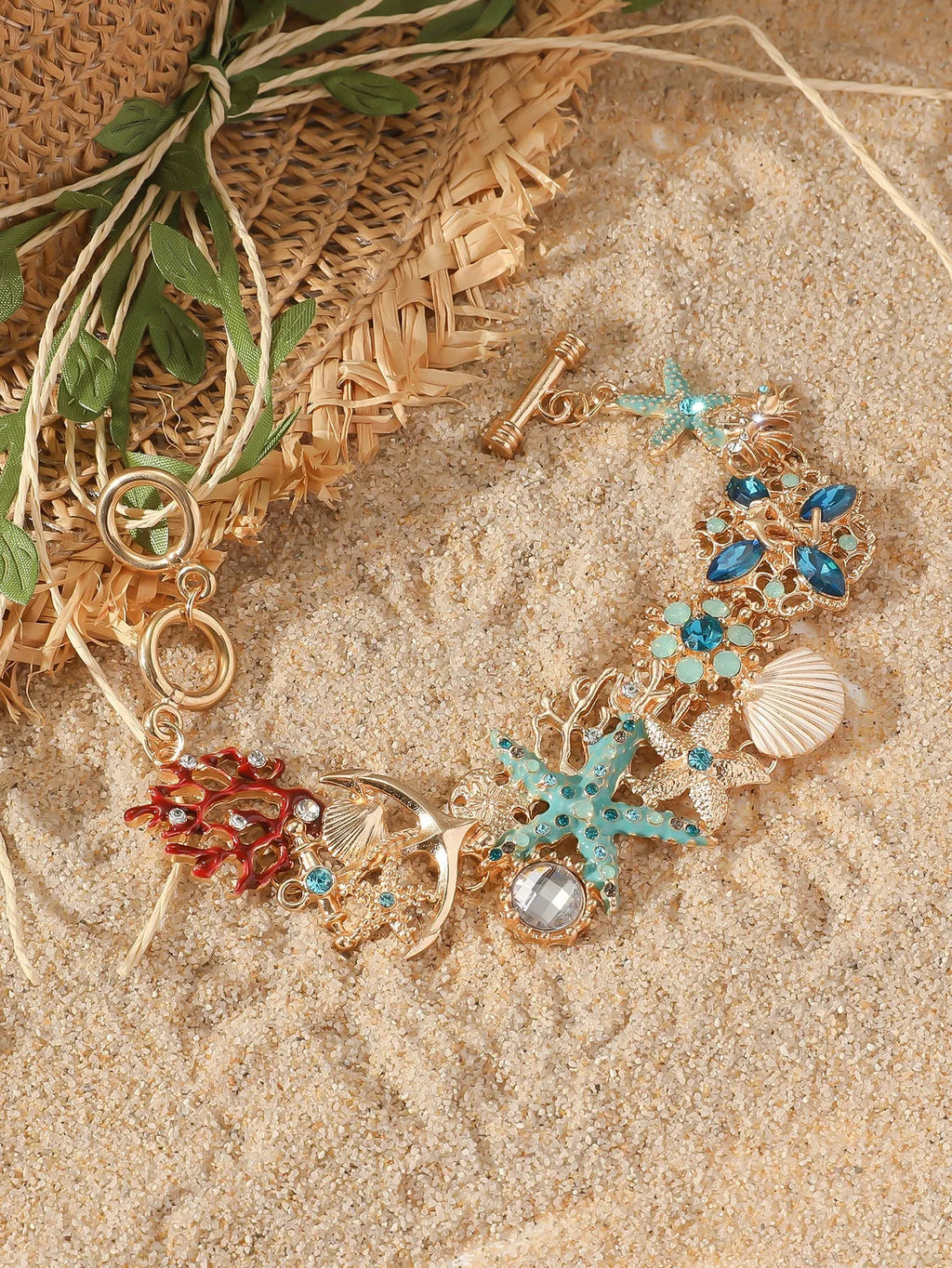 Women's alloy marine theme bracelet with boat anchor, shell, and starfish design in blue.
