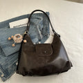 Women's black PU leather single shoulder bag with horizontal square shape and optional pendant attachment