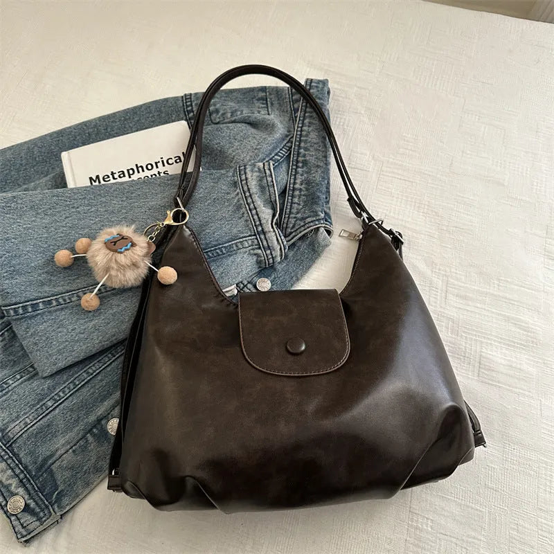 Women's black PU leather single shoulder bag with horizontal square shape and optional pendant attachment