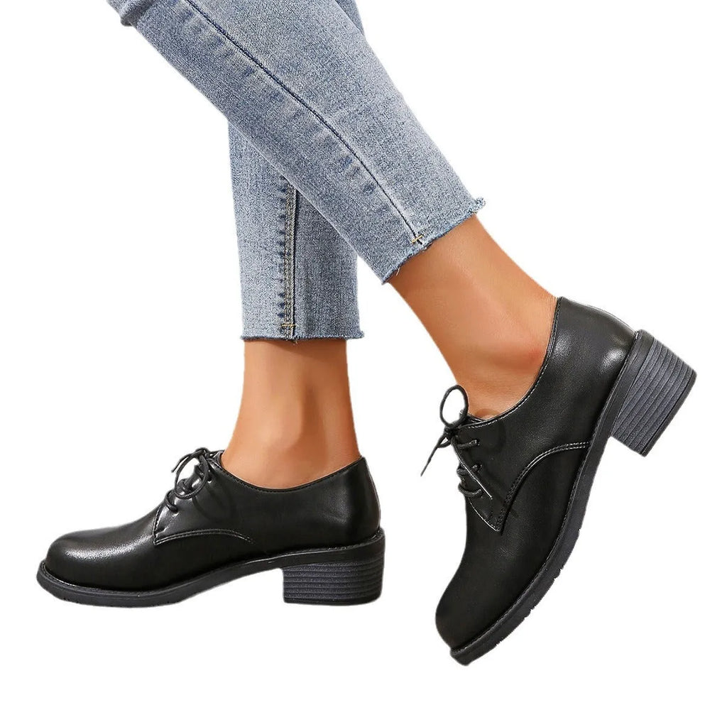Black women's leather shoes with chunky heel, rubber sole, and low-top design for work and casual wear