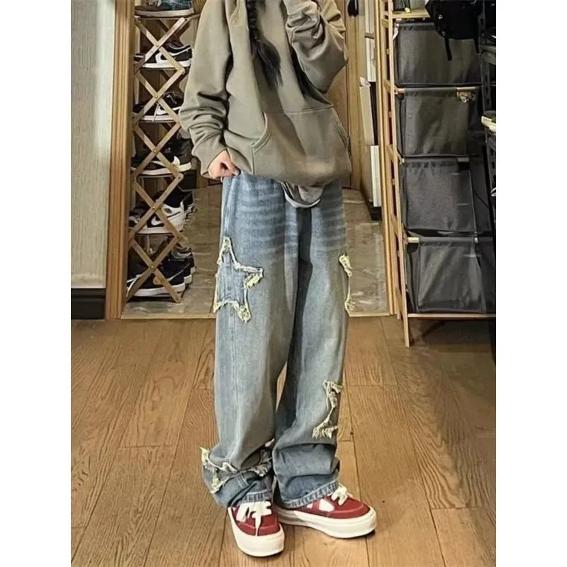 Blue high-waisted wide-leg denim jeans on a neutral background, showing the straight-leg silhouette.