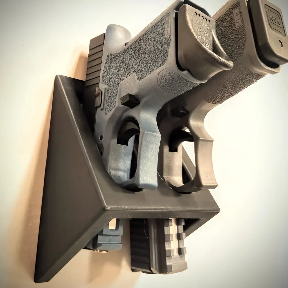 Black plastic punk-style pistol display stand on a flat surface.