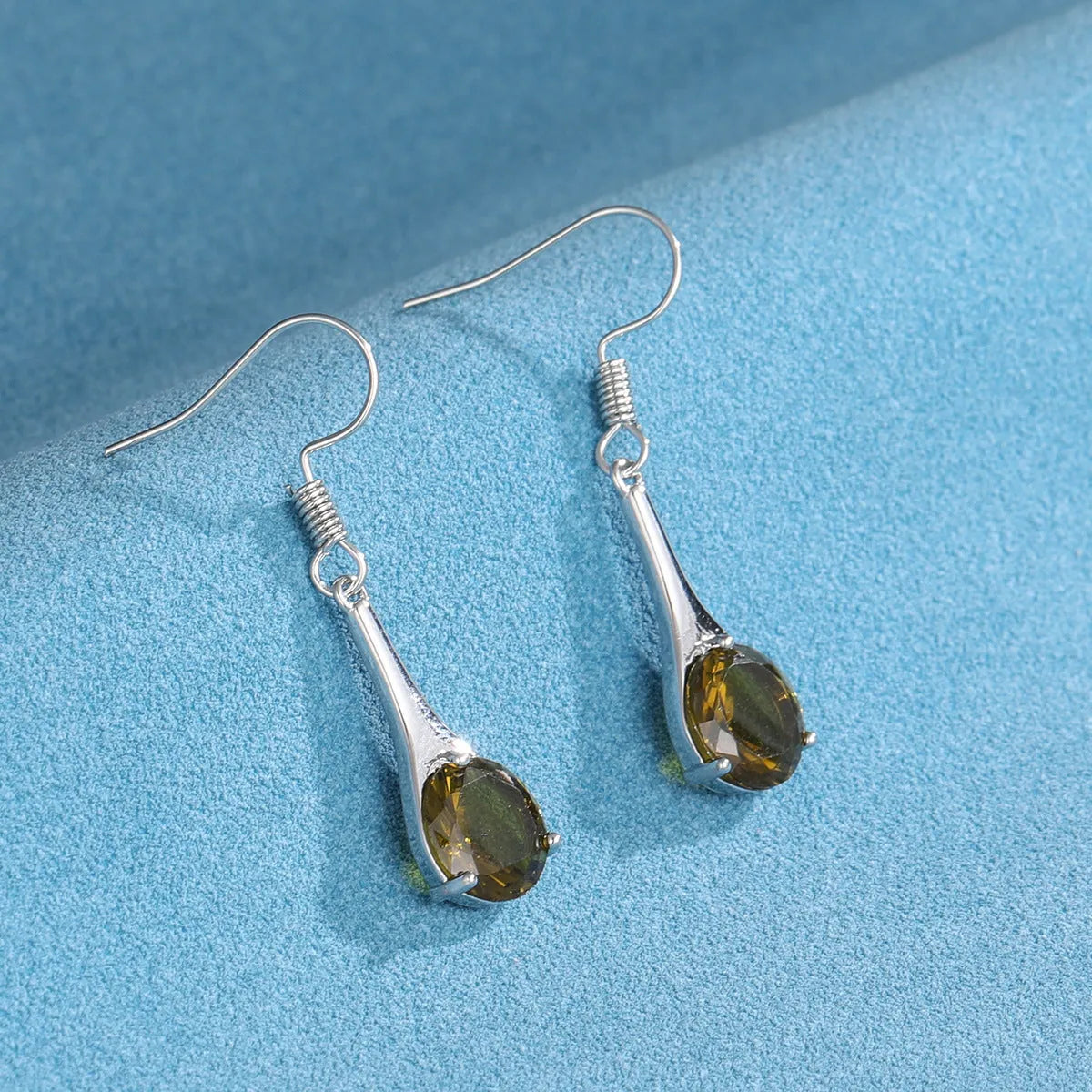 Olive green topaz drop earrings with water shape design and retro style on alloy background