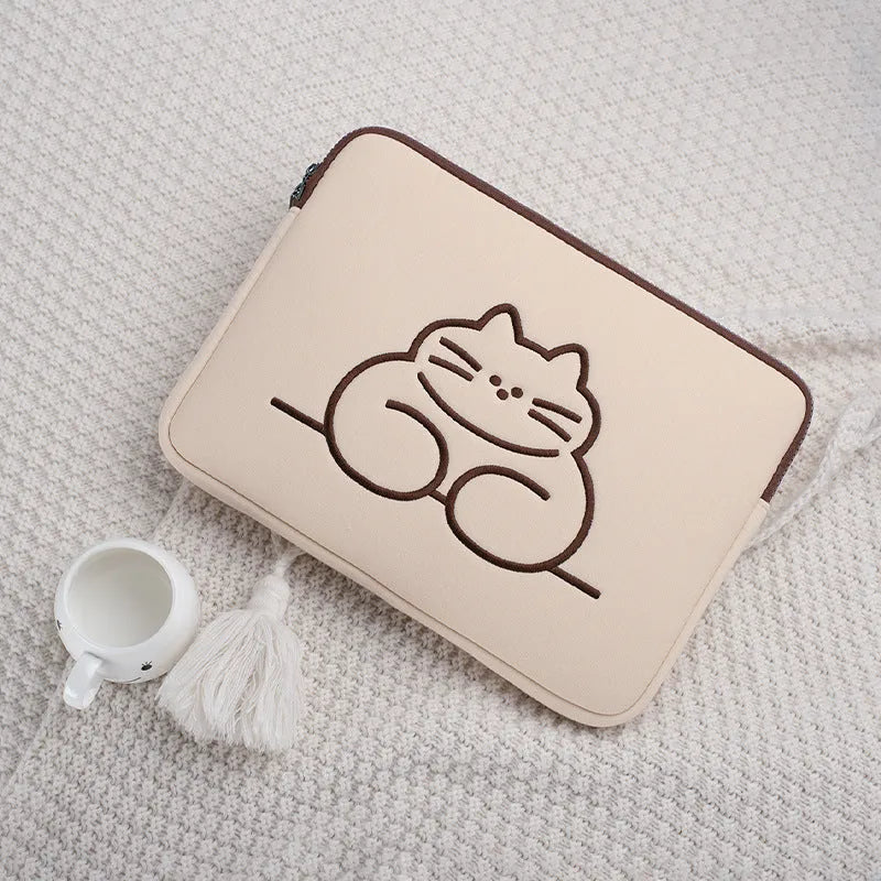 Embroidered laptop sleeve with animal design showing polyester construction and laptop size compatibility