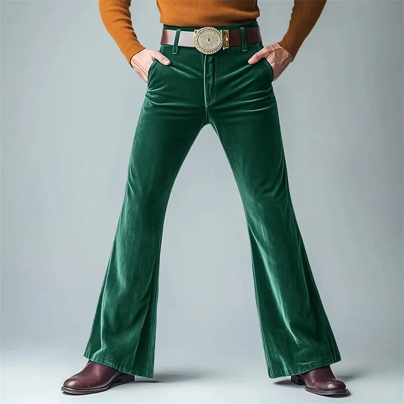 Man wearing gold velvet slim flared suit trousers in dark red for a formal banquet setting.