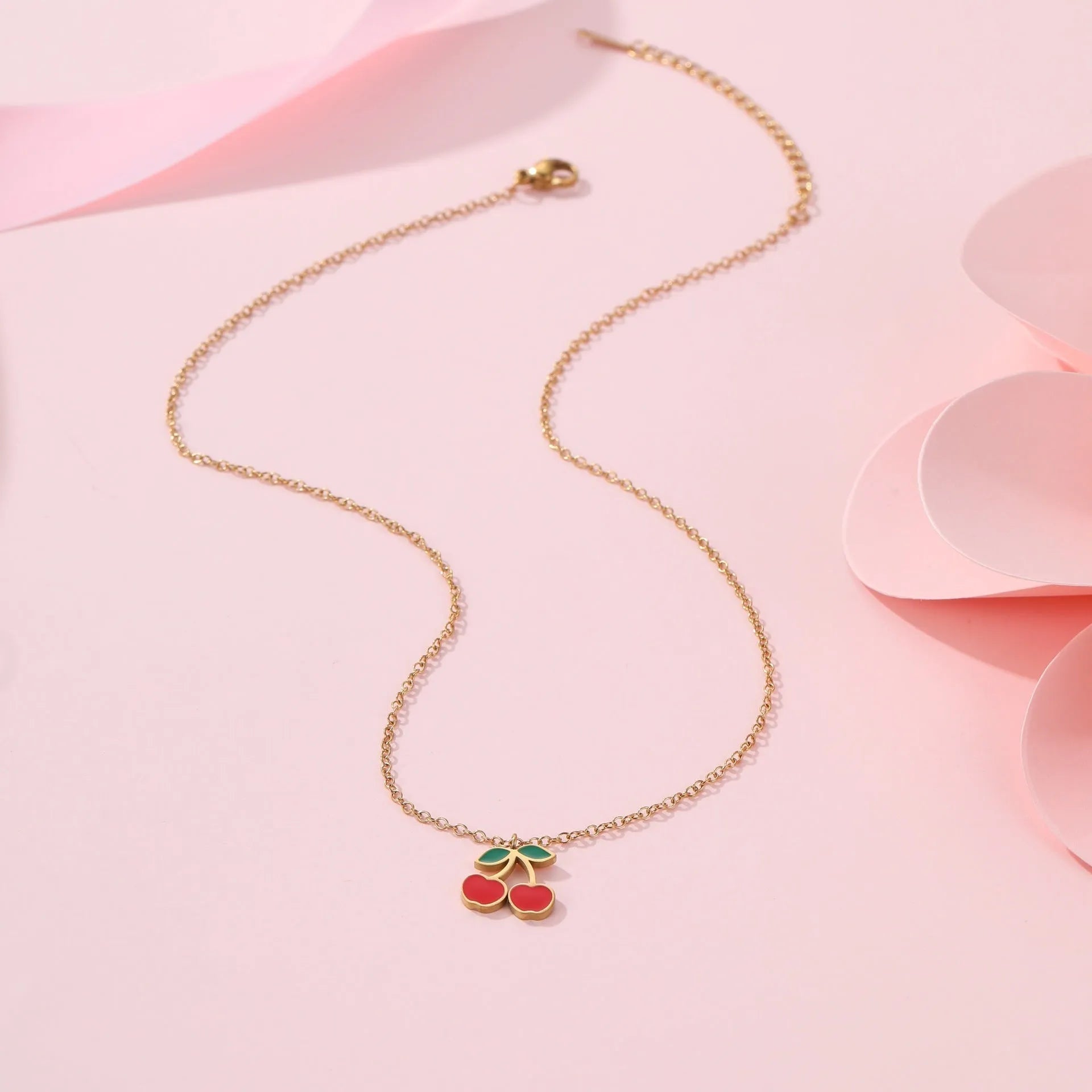 Cherry design stainless steel necklace, bracelet, earrings, and ring set with 18K electroplated finish.